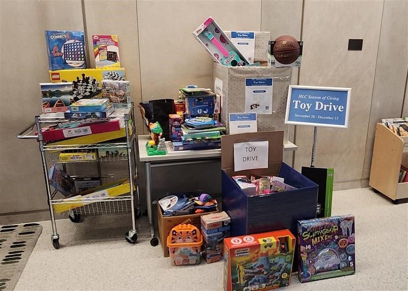 Image of a table with donations of unopened and unwrapped toys for a toy drive